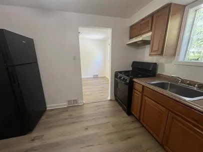 a kitchen with a sink stove and refrigerator