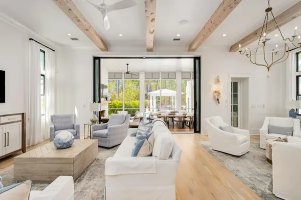 a living room with furniture and large windows