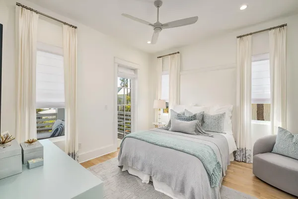 a bedroom with furniture and a large window
