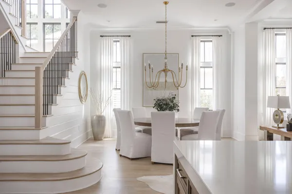 a view of a dining room with furniture wooden floor and a chandelier