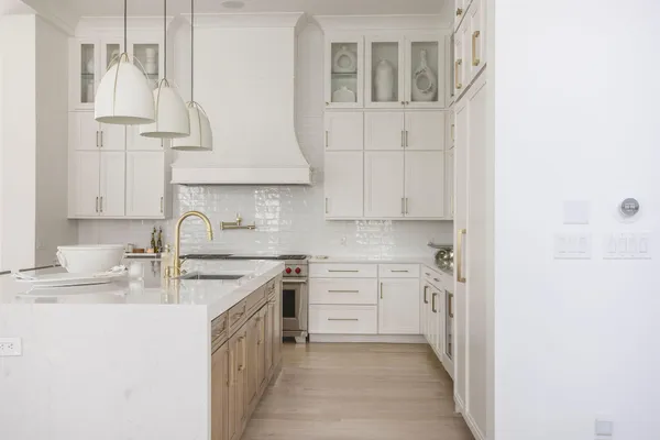 a kitchen with stainless steel appliances granite countertop a sink stove and cabinets