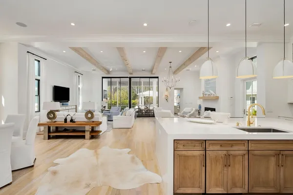 a living room with kitchen island furniture and a flat screen tv