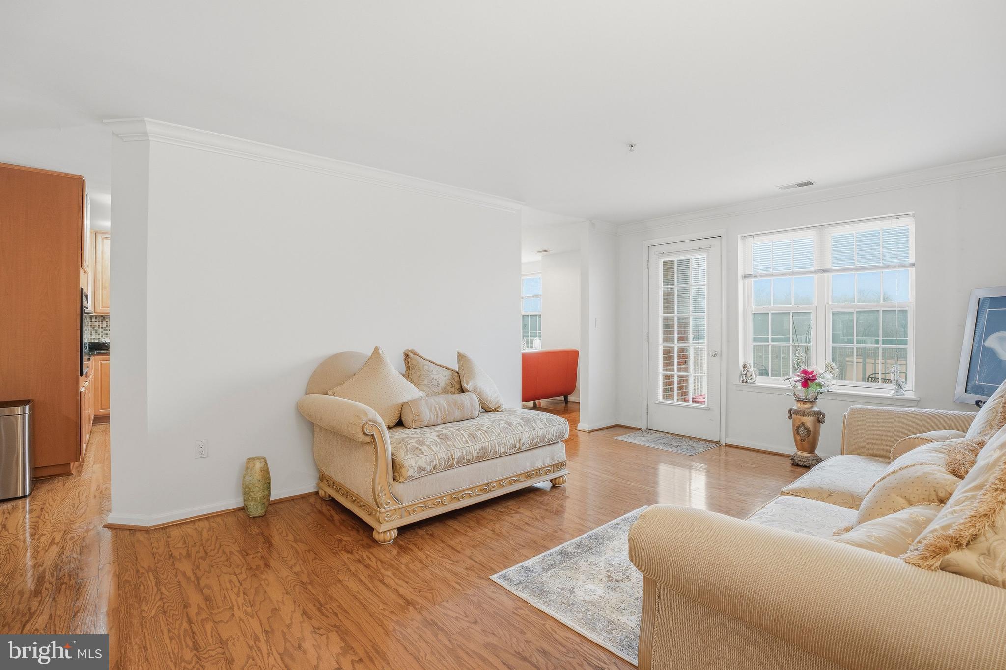 9500 Sidebrook Road, Unit 406 Owings Mills, MD 21117 - Photo 10 of 35 a living room with furniture and a large window