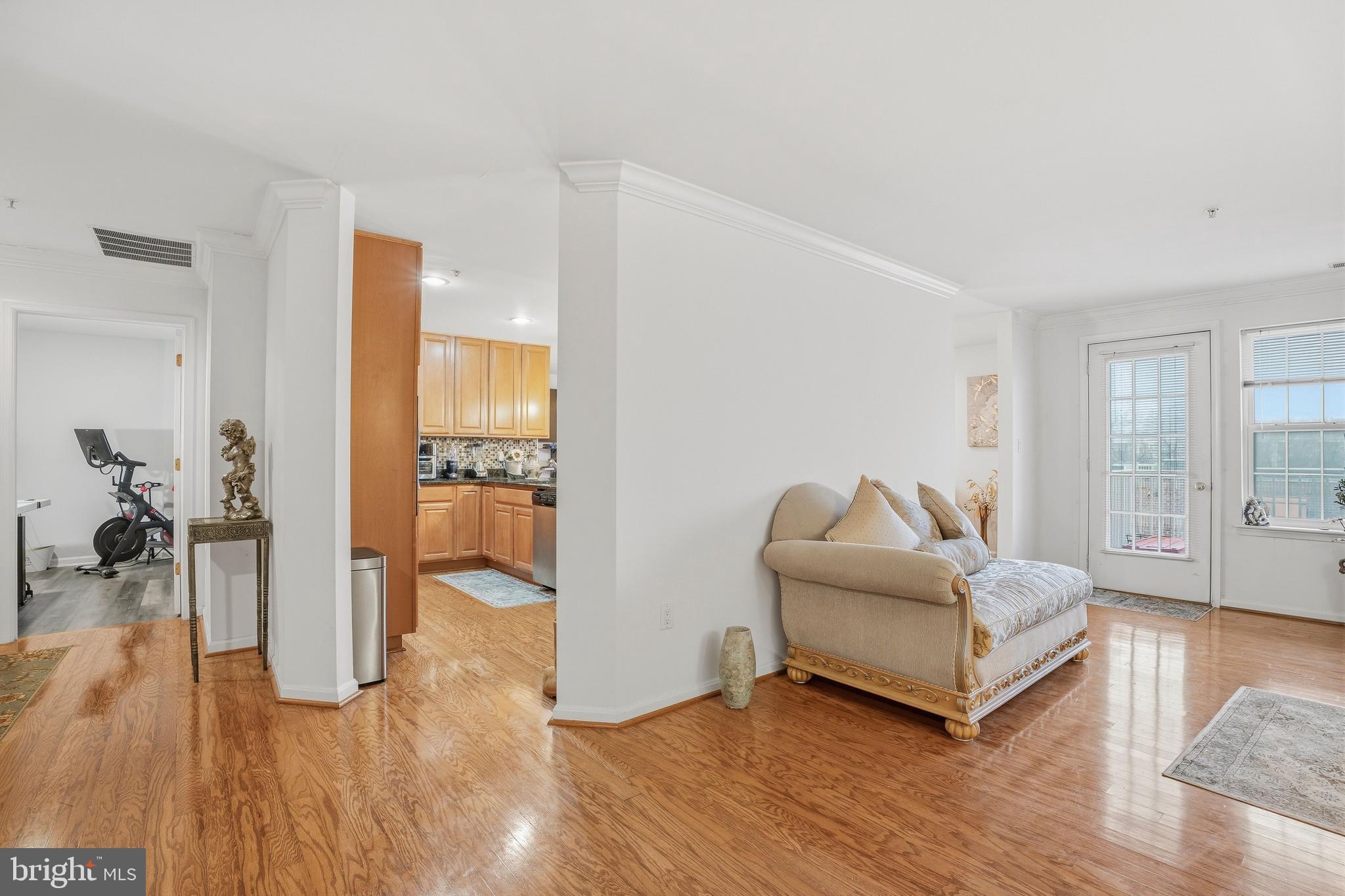 9500 Sidebrook Road, Unit 406 Owings Mills, MD 21117 - Photo 11 of 35 a living room with furniture and a wooden floor
