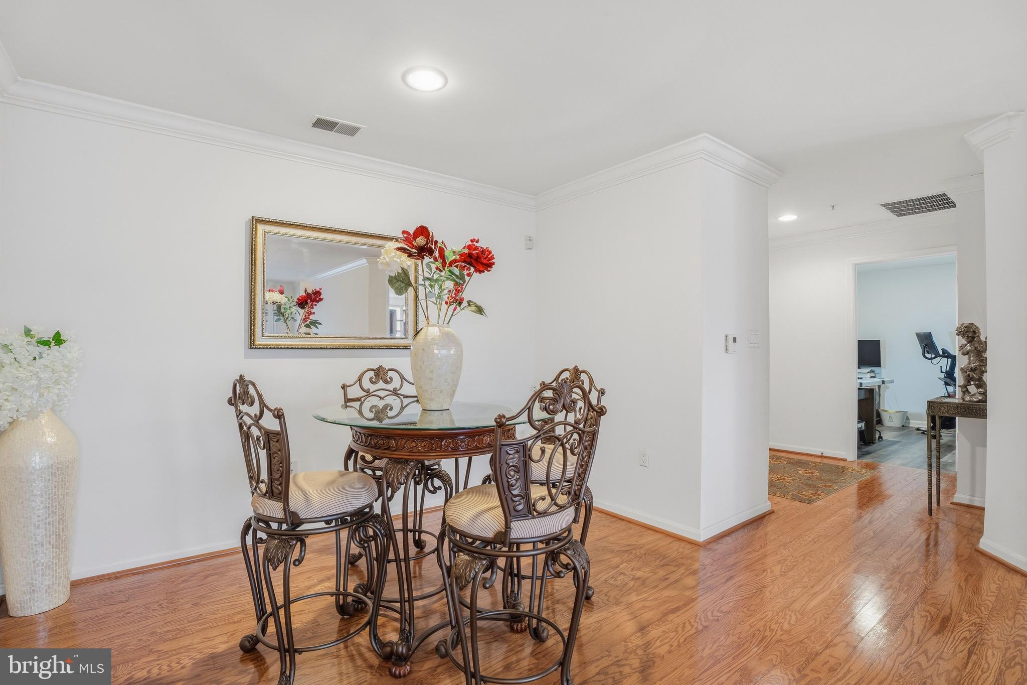 9500 Sidebrook Road, Unit 406 Owings Mills, MD 21117 - Photo 12 of 35 a view of a dining room with furniture and wooden floor
