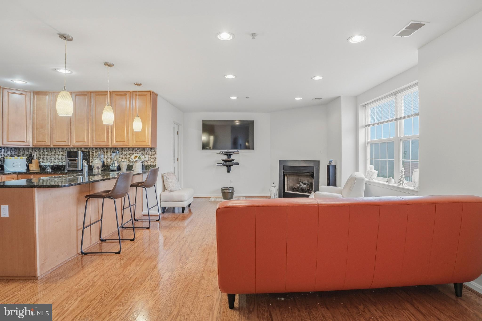 9500 Sidebrook Road, Unit 406 Owings Mills, MD 21117 - Photo 16 of 35 a living room with fireplace furniture and a wooden floor