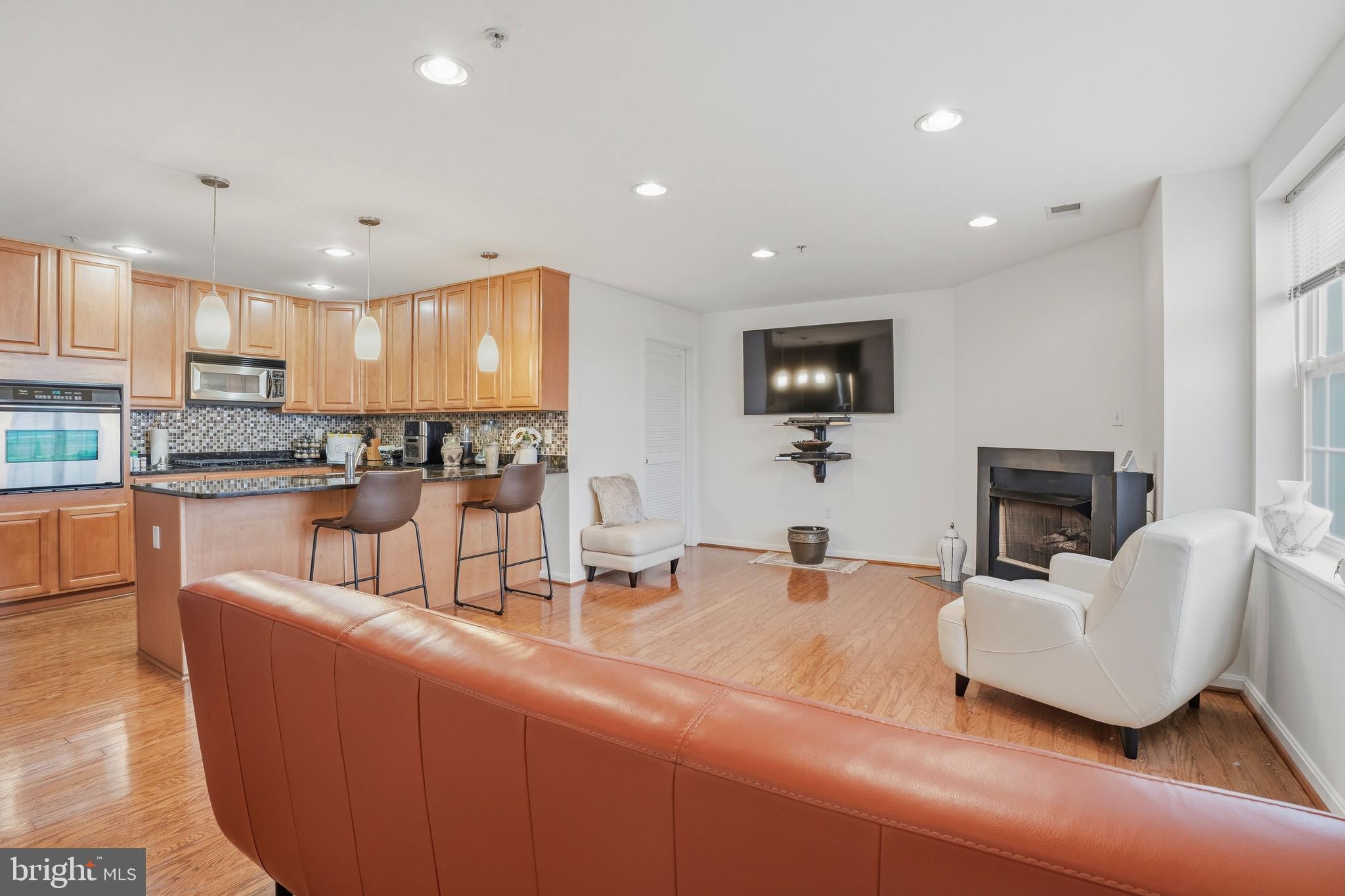9500 Sidebrook Road, Unit 406 Owings Mills, MD 21117 - Photo 19 of 35 a kitchen with kitchen island granite countertop a sink and a refrigerator
