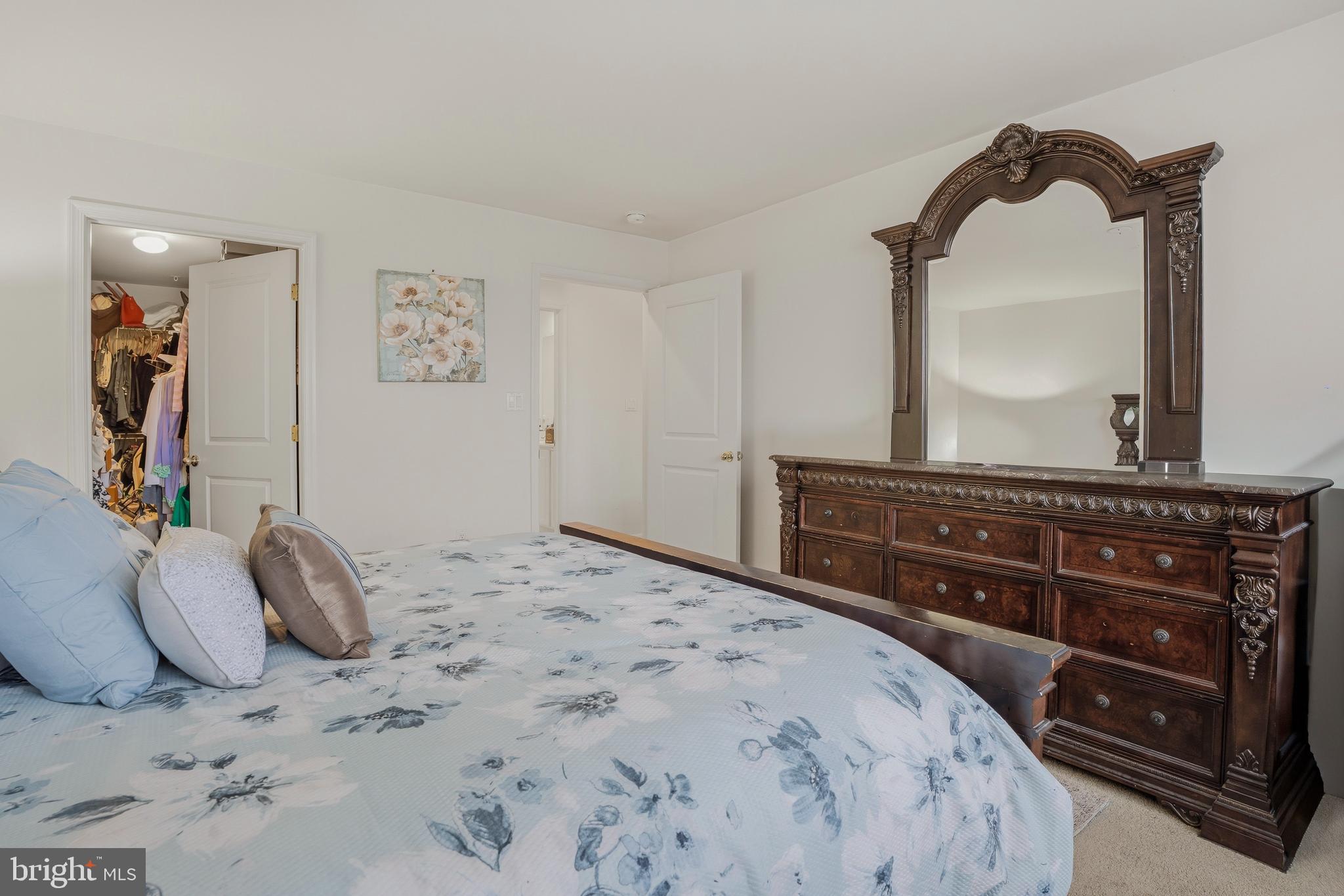9500 Sidebrook Road, Unit 406 Owings Mills, MD 21117 - Photo 20 of 35 a bedroom with a bed and a mirror