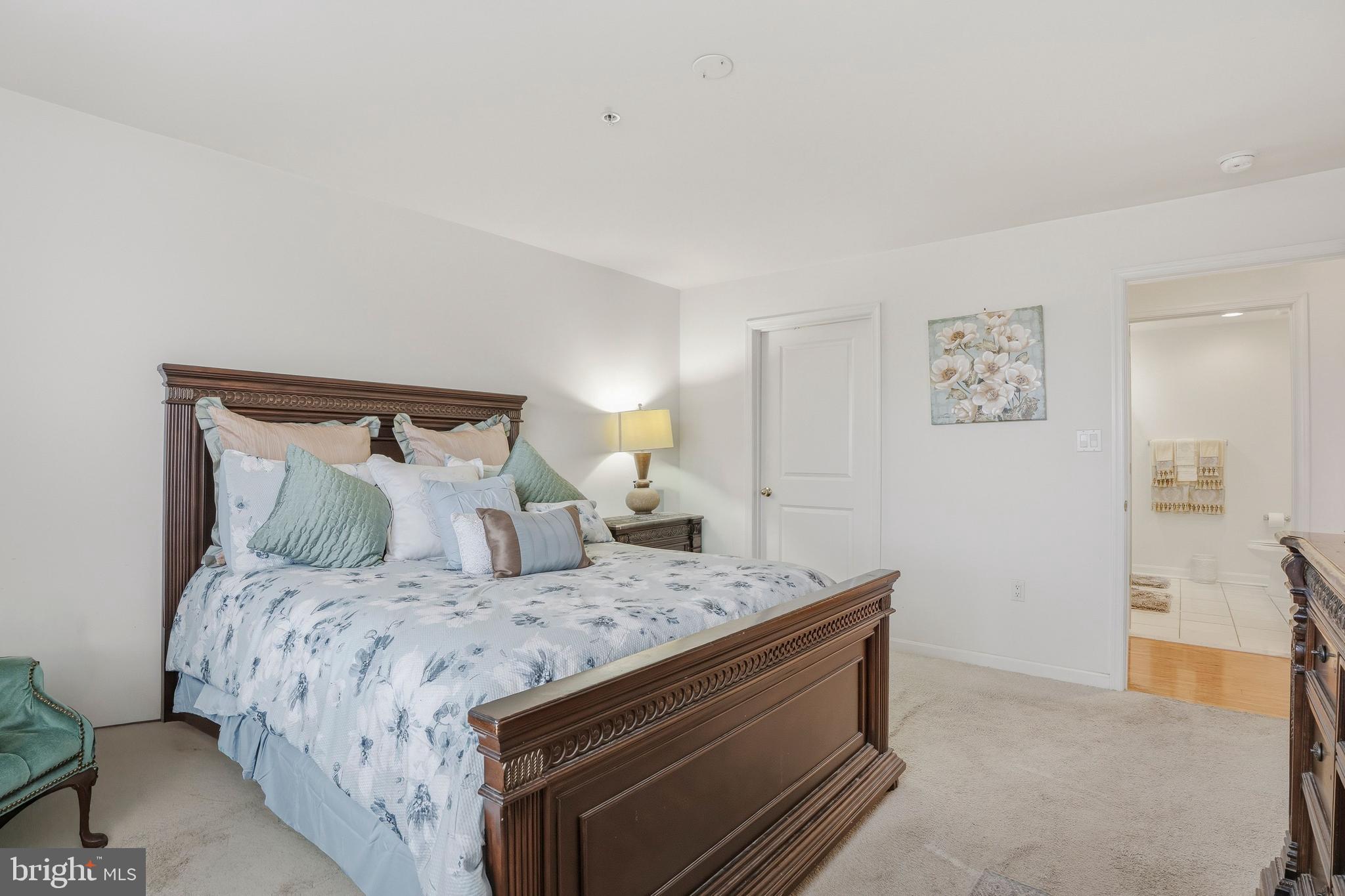 9500 Sidebrook Road, Unit 406 Owings Mills, MD 21117 - Photo 21 of 35 a bedroom with a bed and painting on the wall