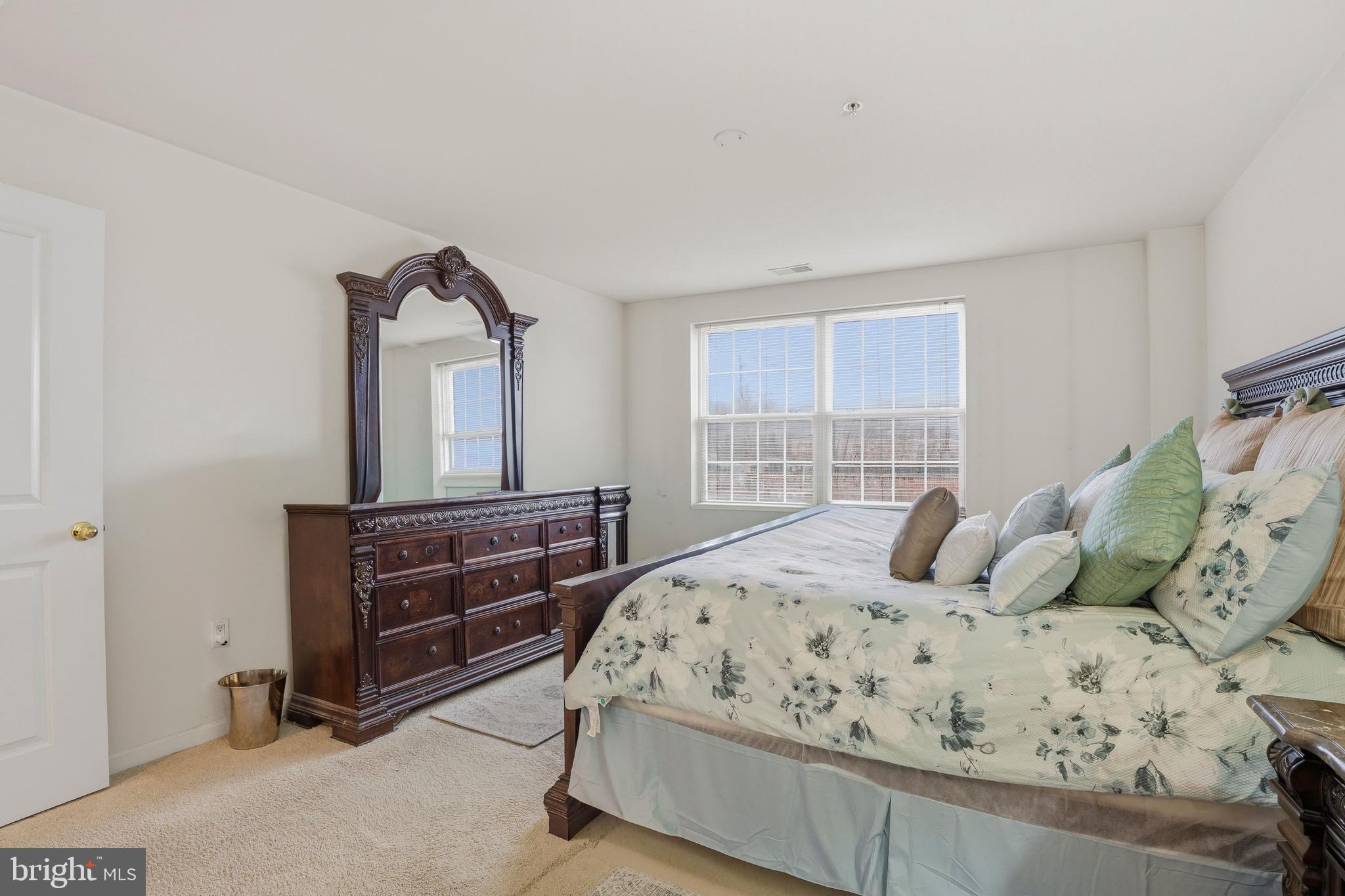 9500 Sidebrook Road, Unit 406 Owings Mills, MD 21117 - Photo 22 of 35 a bedroom with a bed and a dresser