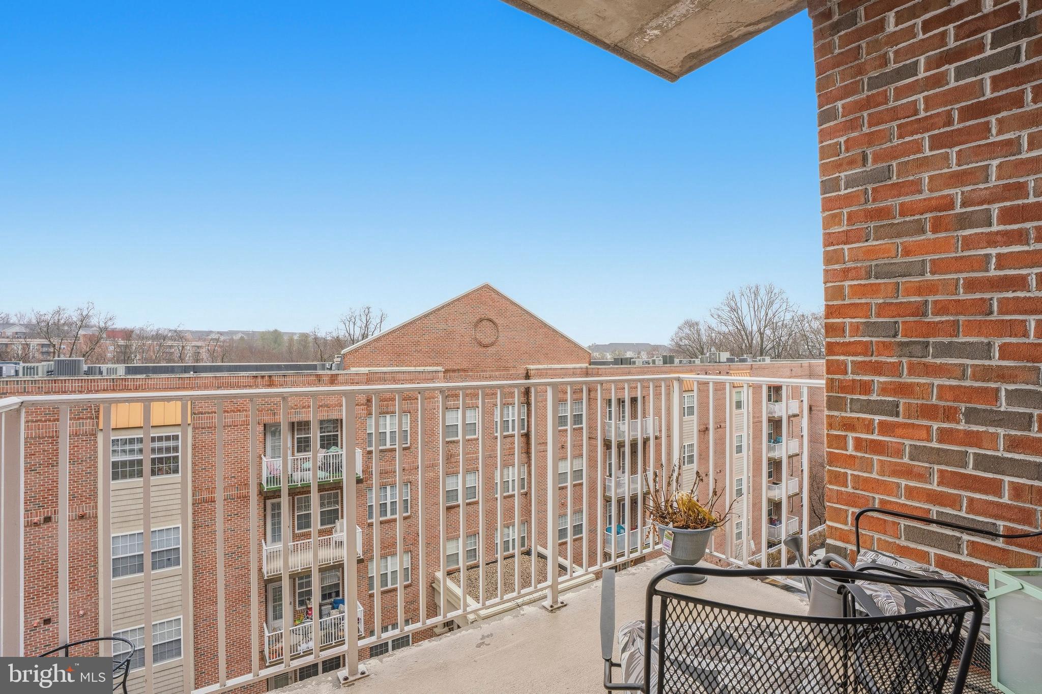 9500 Sidebrook Road, Unit 406 Owings Mills, MD 21117 - Photo 31 of 35 a view of a balcony with two chairs and a table