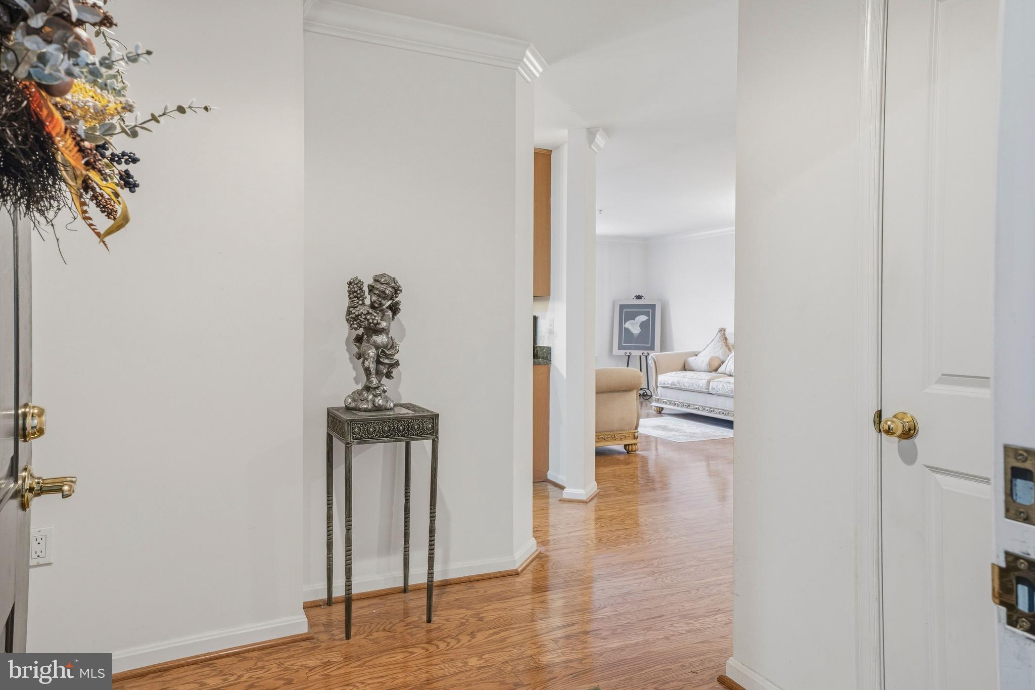 9500 Sidebrook Road, Unit 406 Owings Mills, MD 21117 - Photo 7 of 35 a view of a hallway with wooden floor windows and a bathroom