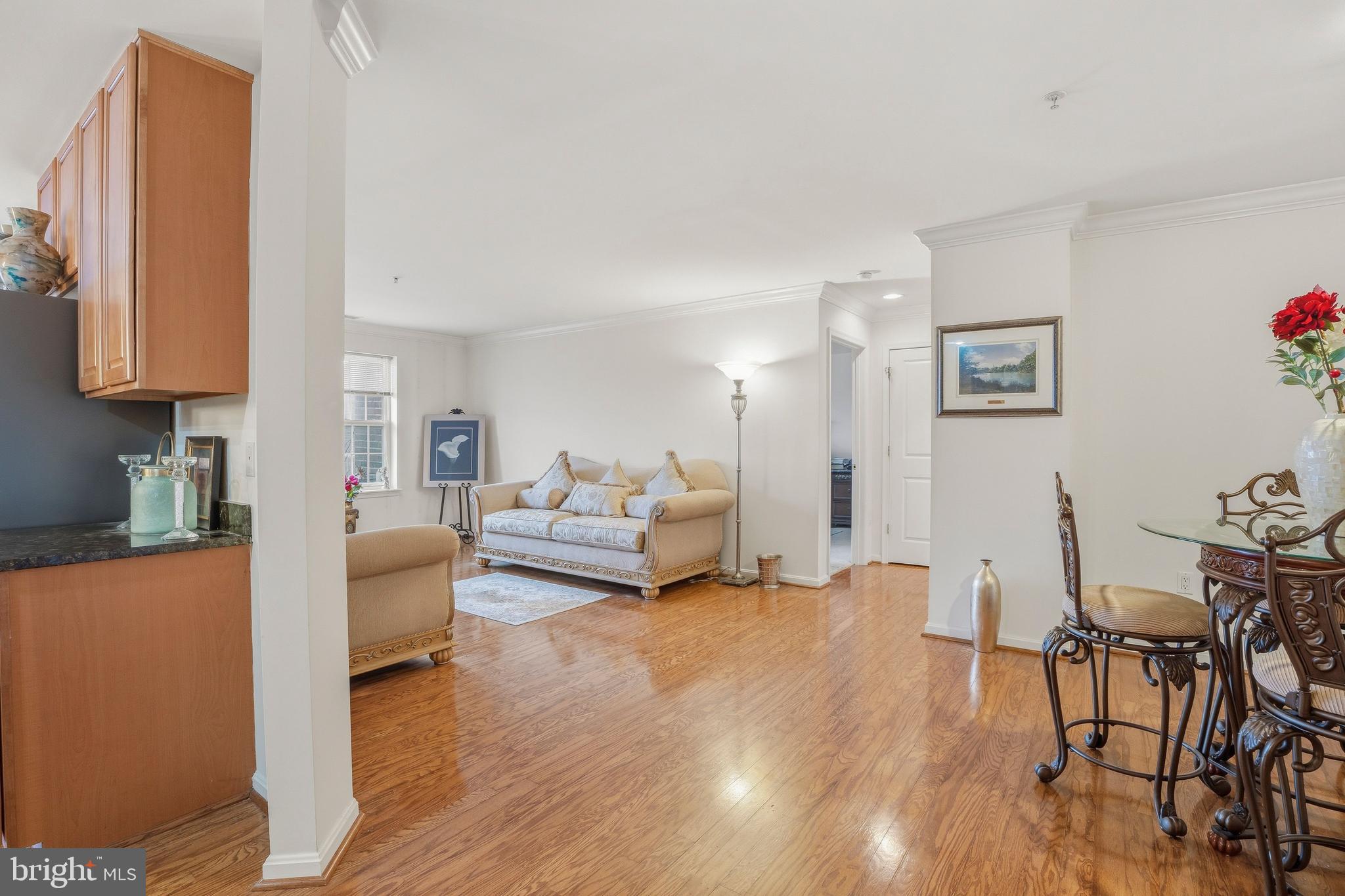 9500 Sidebrook Road, Unit 406 Owings Mills, MD 21117 - Photo 8 of 35 a living room with furniture and a wooden floor