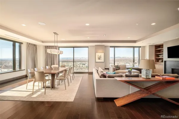 a living room with furniture a flat screen tv and a large window