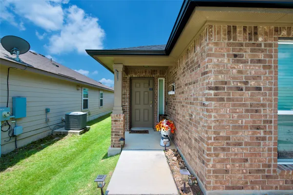 a view of front door of house with a yard