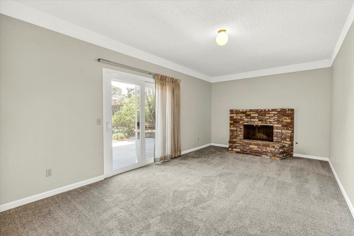 3111 Carmelo Circle Marina, CA 93933 - Photo 15 of 35 an empty room with furniture and a fireplace