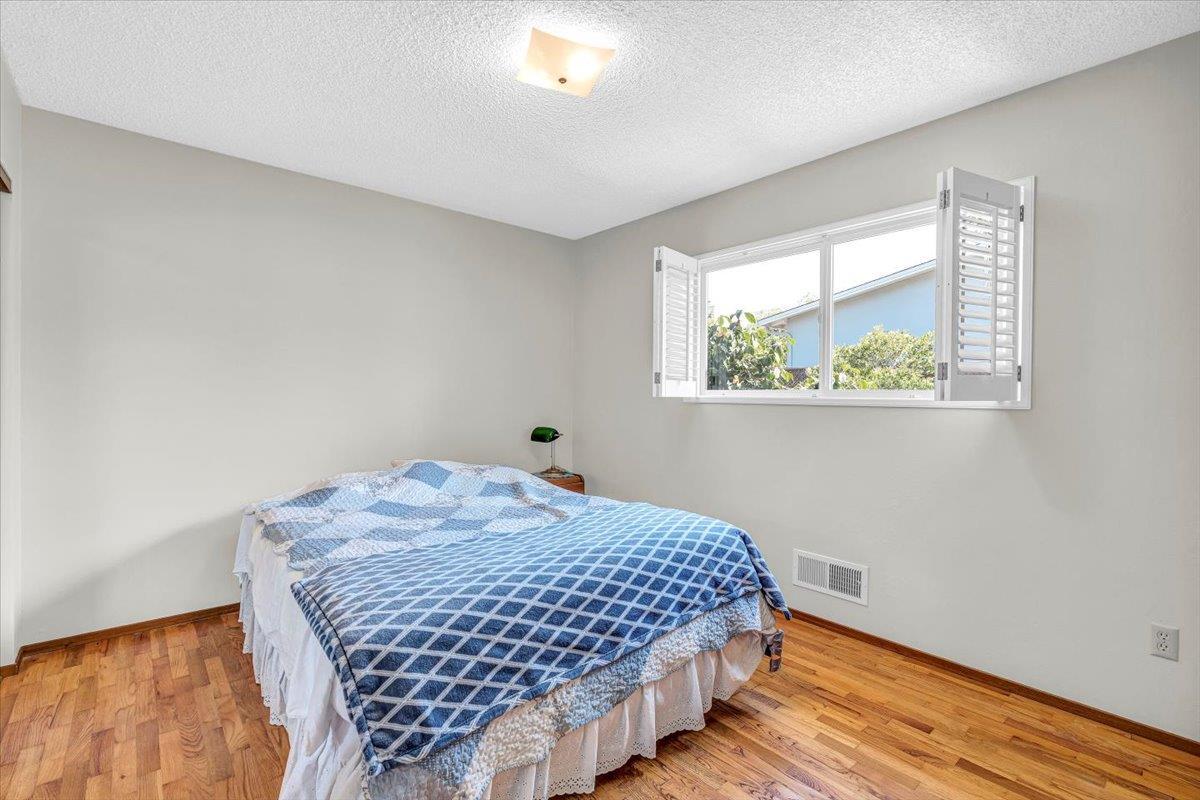 3111 Carmelo Circle Marina, CA 93933 - Photo 22 of 35 a bedroom with a bed and a window