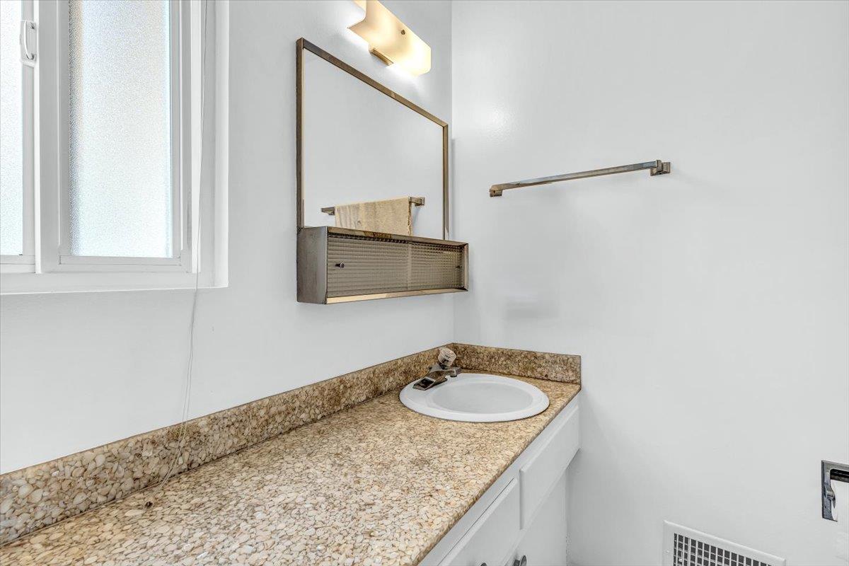 3111 Carmelo Circle Marina, CA 93933 - Photo 25 of 35 a bathroom with a granite countertop sink and a mirror