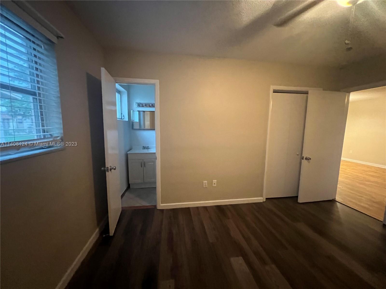 5507 Southwest 7th Court Margate, FL 33068 - Photo 11 of 21 an empty room with wooden floor and windows
