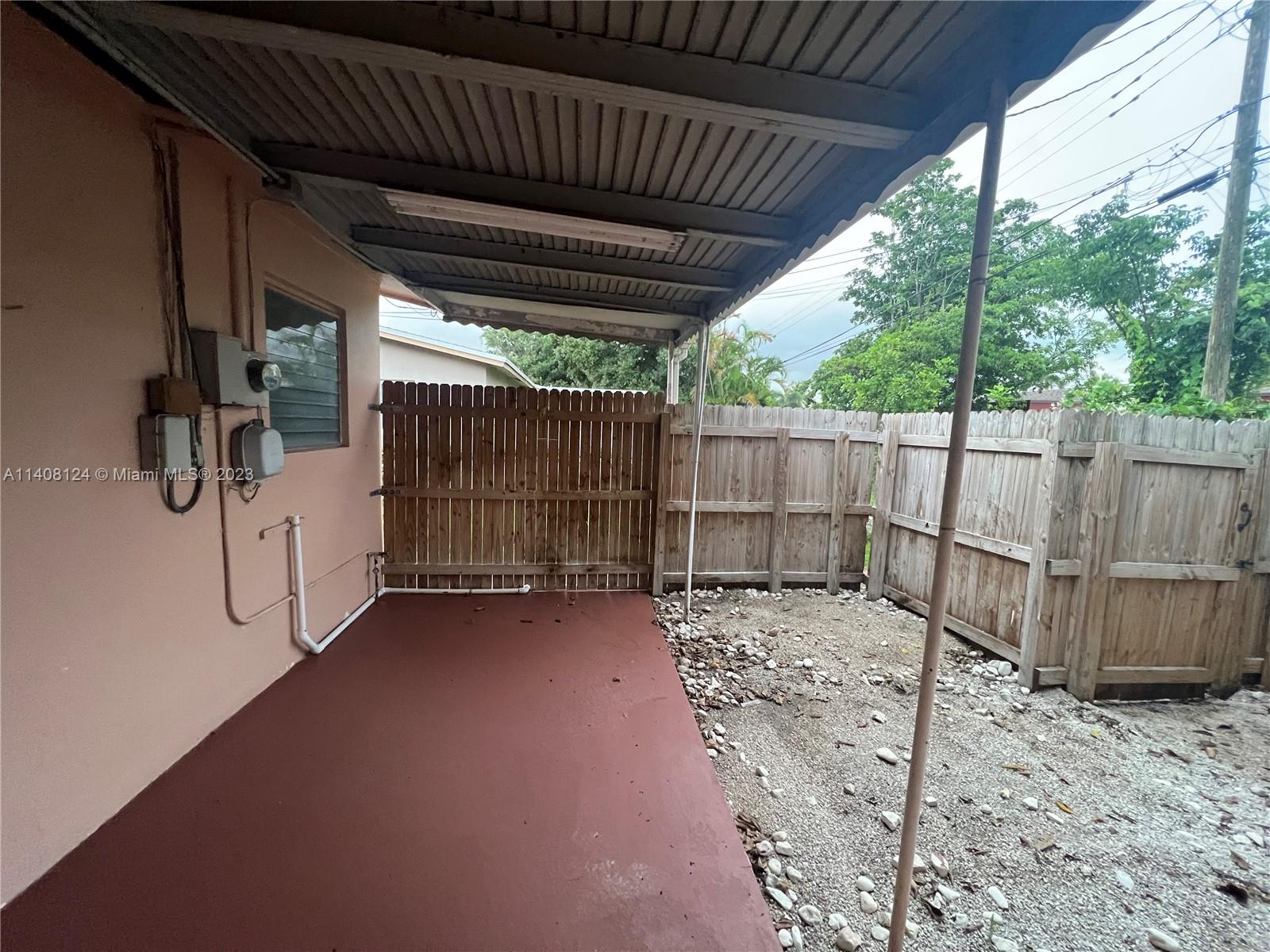 5507 Southwest 7th Court Margate, FL 33068 - Photo 17 of 21 a view of a backyard with wooden fence and trees
