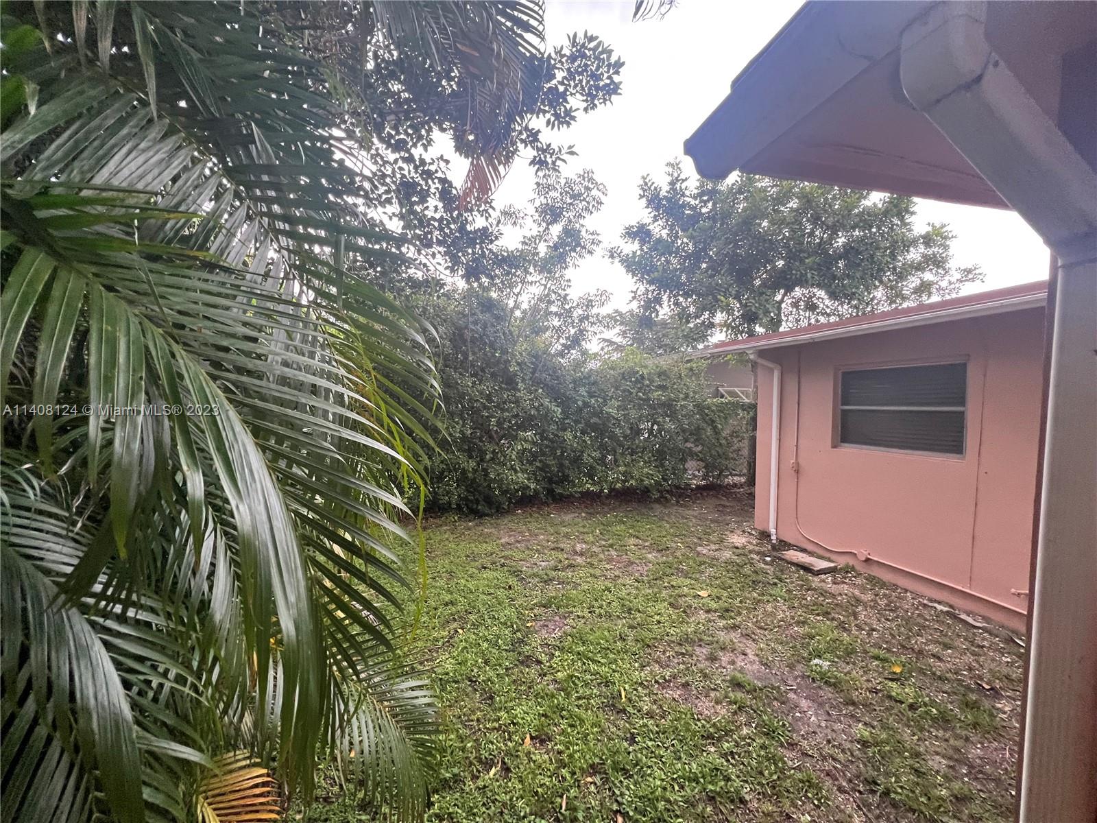 5507 Southwest 7th Court Margate, FL 33068 - Photo 19 of 21 a view of backyard with tub and trees