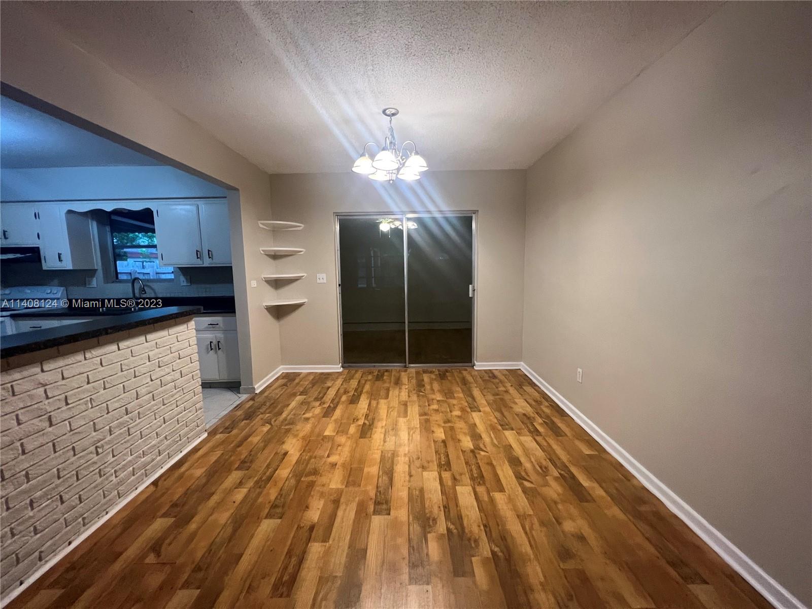 5507 Southwest 7th Court Margate, FL 33068 - Photo 5 of 21 a view of a kitchen with a sink and dishwasher with wooden floor