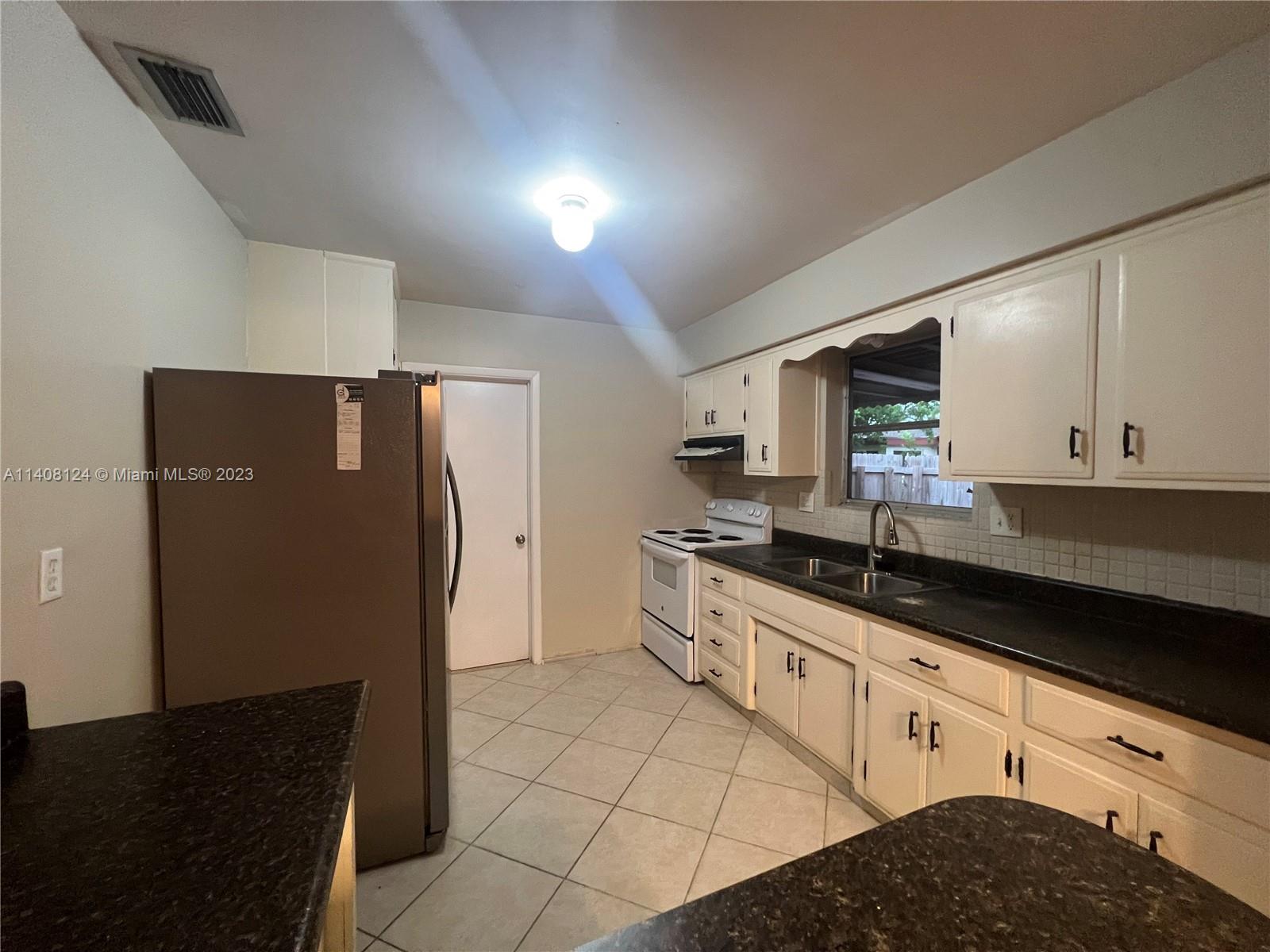 5507 Southwest 7th Court Margate, FL 33068 - Photo 6 of 21 a large kitchen with cabinets