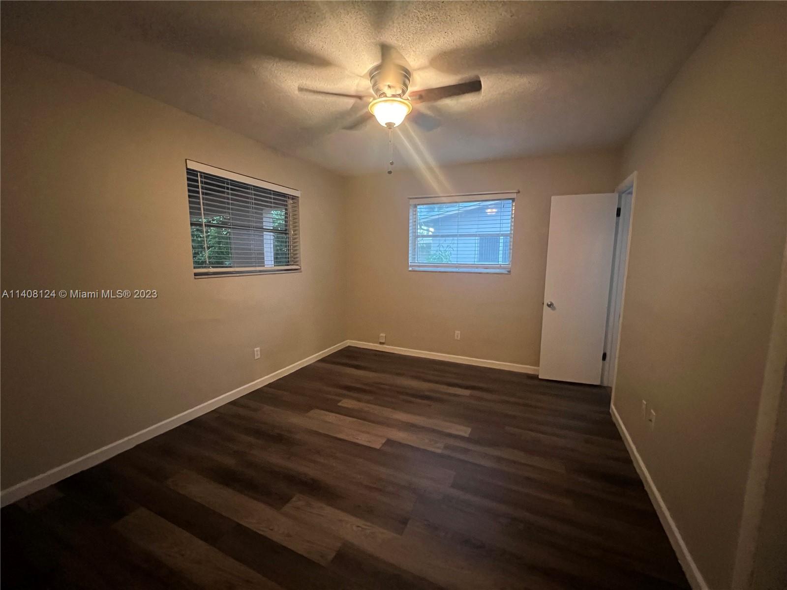 5507 Southwest 7th Court Margate, FL 33068 - Photo 10 of 21 a view of an empty room with wooden floor and a ceiling fan