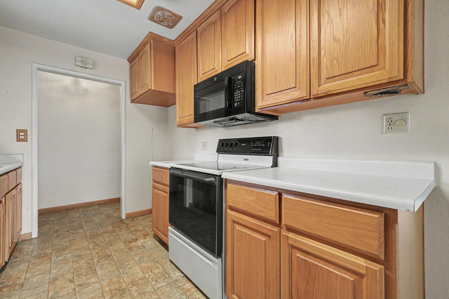 626 Sutter Lane Ione, CA 95640 - Photo 2 of 21 a kitchen with stainless steel appliances granite countertop a stove a microwave and a sink