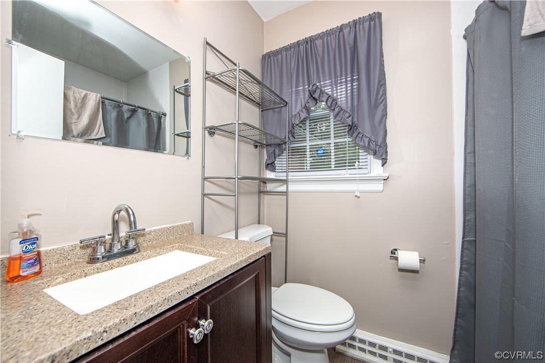 5505 Raleigh Road Henrico, VA 23231 - Photo 14 of 30 a bathroom with a granite countertop sink a toilet and a mirror