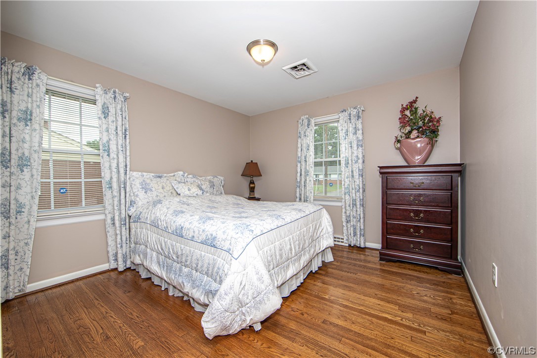 5505 Raleigh Road Henrico, VA 23231 - Photo 15 of 30 a bedroom with a bed and wooden floor