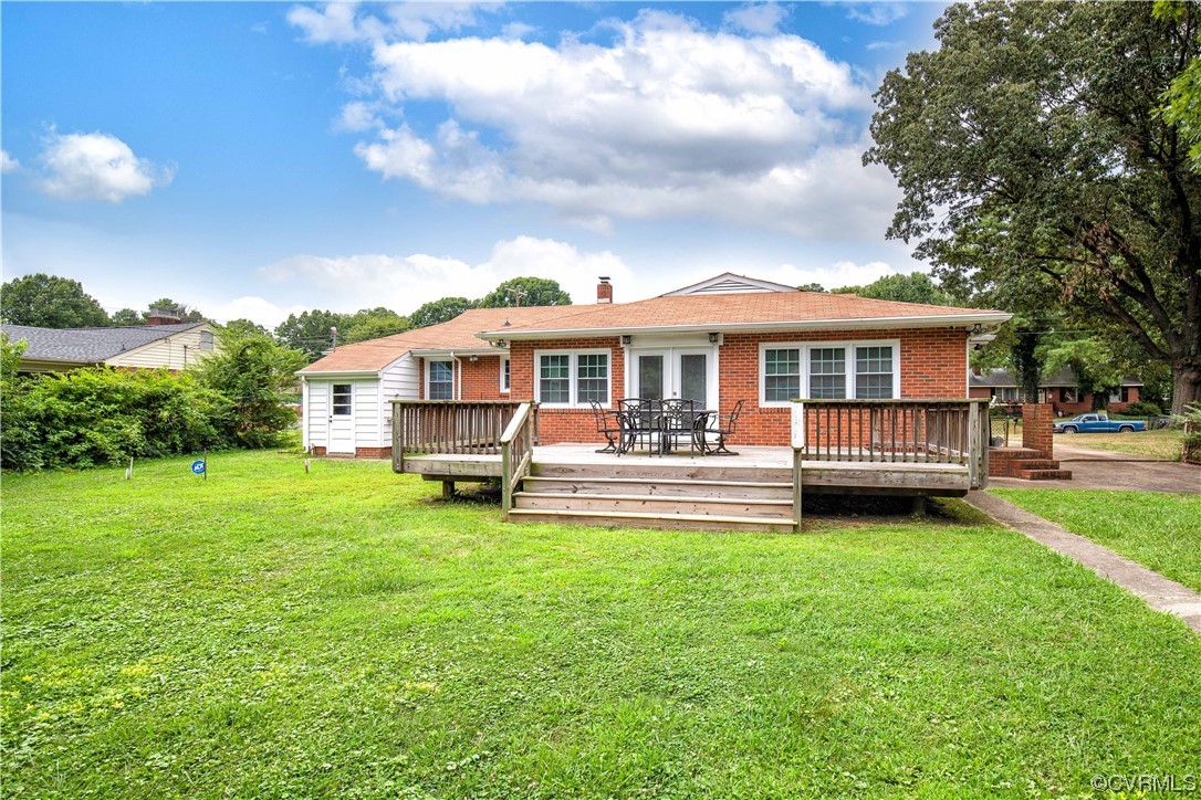 5505 Raleigh Road Henrico, VA 23231 - Photo 22 of 30 a view of a house with a backyard and a patio
