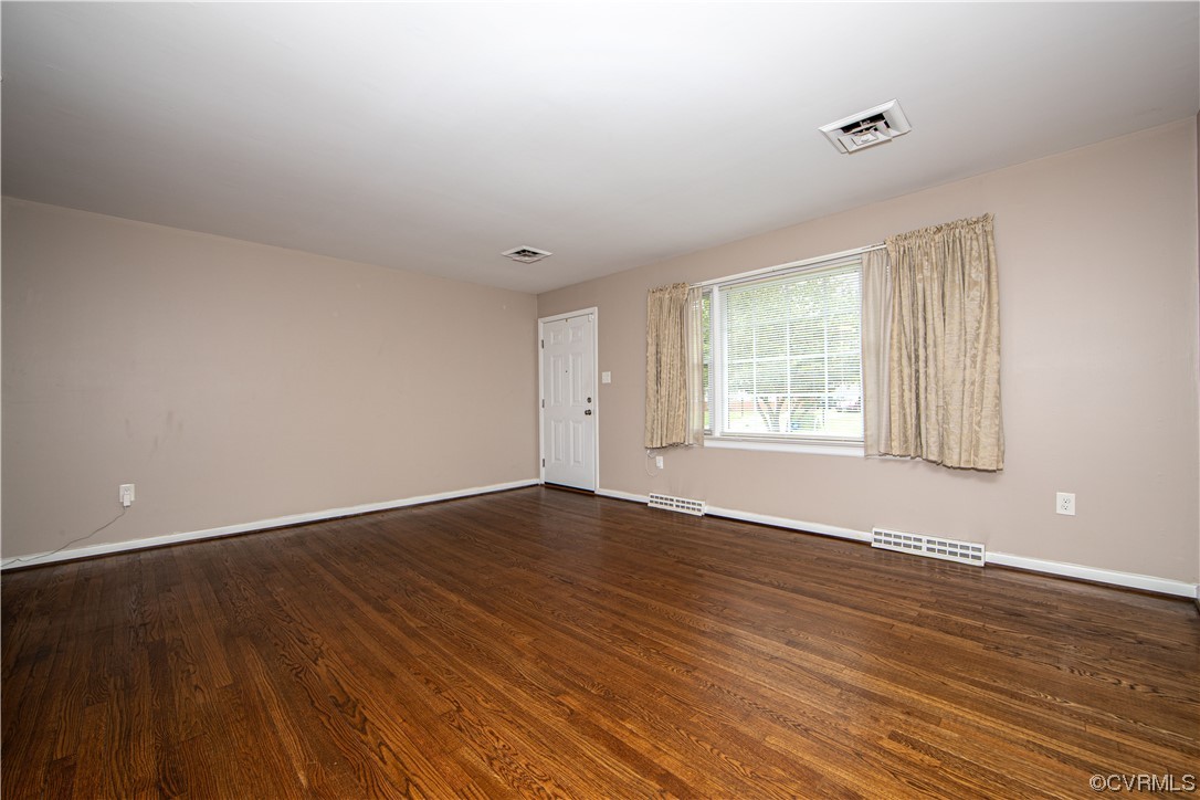 5505 Raleigh Road Henrico, VA 23231 - Photo 3 of 30 a view of an empty room with wooden floor and a window