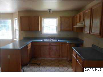 157 Meadow Ridge Road Troy, VA 22974 - Photo 3 of 11 a kitchen with kitchen island sink and cabinets