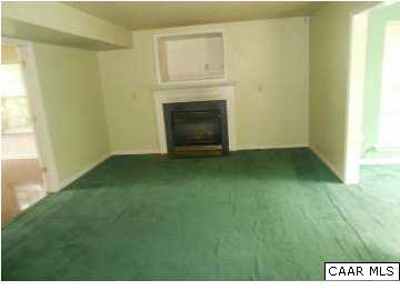 157 Meadow Ridge Road Troy, VA 22974 - Photo 4 of 11 a view of an empty room with a fireplace and a window