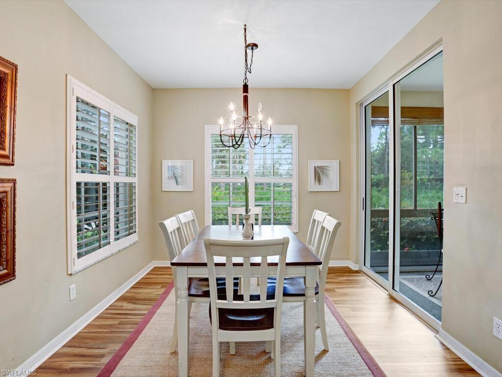 352 Bay Forest Drive, Unit 103 Naples, FL 34110 - Photo 11 of 30 a view of a dining room with furniture wooden floor and windows
