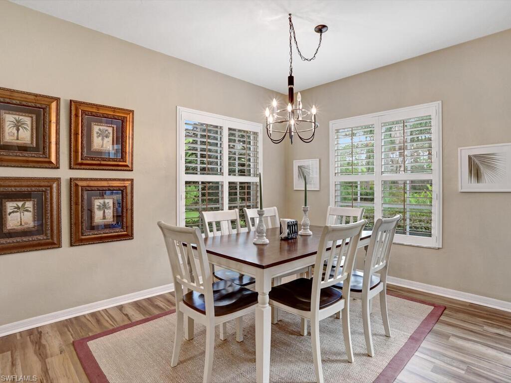 352 Bay Forest Drive, Unit 103 Naples, FL 34110 - Photo 12 of 30 a view of a dining room with furniture window and wooden floor