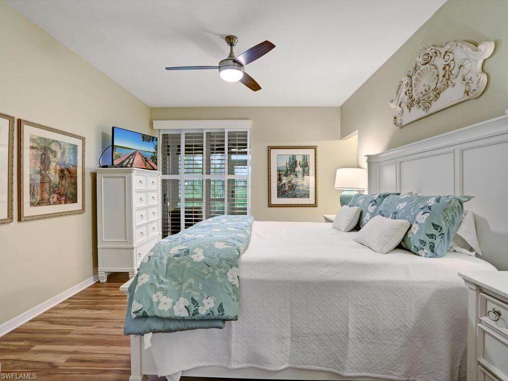 352 Bay Forest Drive, Unit 103 Naples, FL 34110 - Photo 13 of 30 a bedroom with a large bed and a window