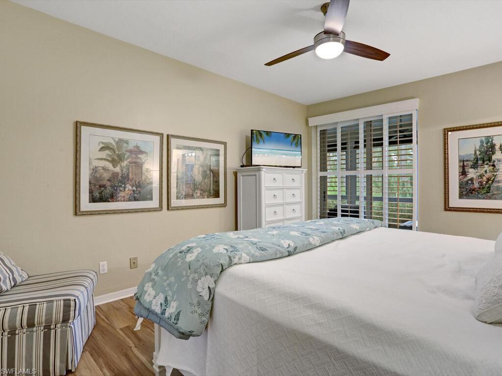 352 Bay Forest Drive, Unit 103 Naples, FL 34110 - Photo 14 of 30 a bedroom with a bed and a window