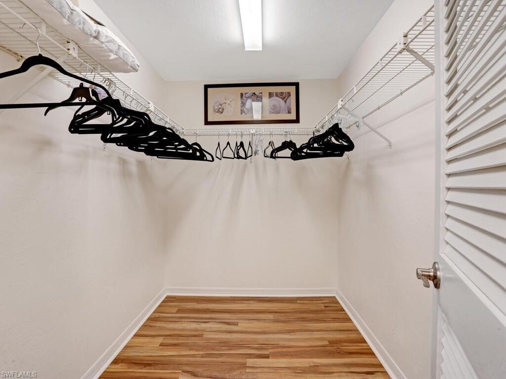 352 Bay Forest Drive, Unit 103 Naples, FL 34110 - Photo 16 of 30 a view of a hallway with wooden floor and entryway