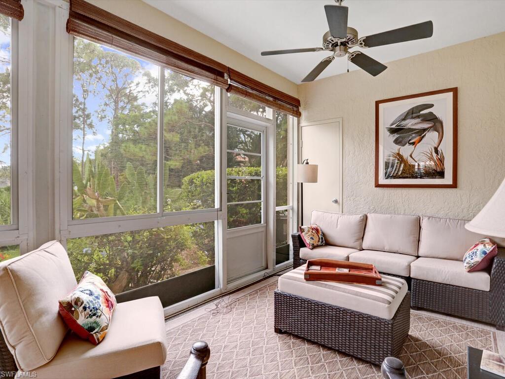 352 Bay Forest Drive, Unit 103 Naples, FL 34110 - Photo 2 of 30 a living room with furniture and a large window