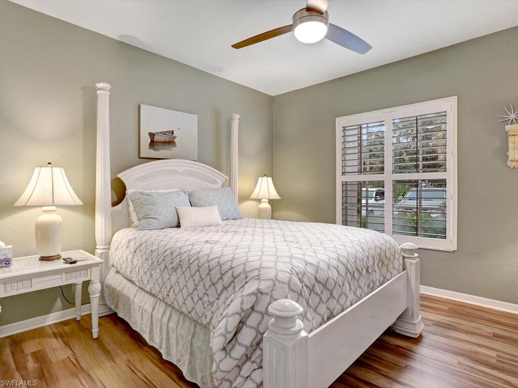 352 Bay Forest Drive, Unit 103 Naples, FL 34110 - Photo 21 of 30 a bedroom with bed and a window