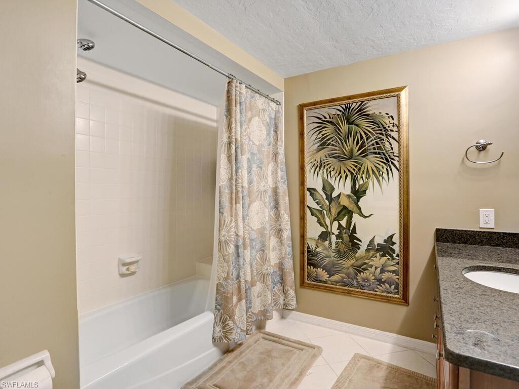 352 Bay Forest Drive, Unit 103 Naples, FL 34110 - Photo 24 of 30 a bathroom with a bathtub and shower