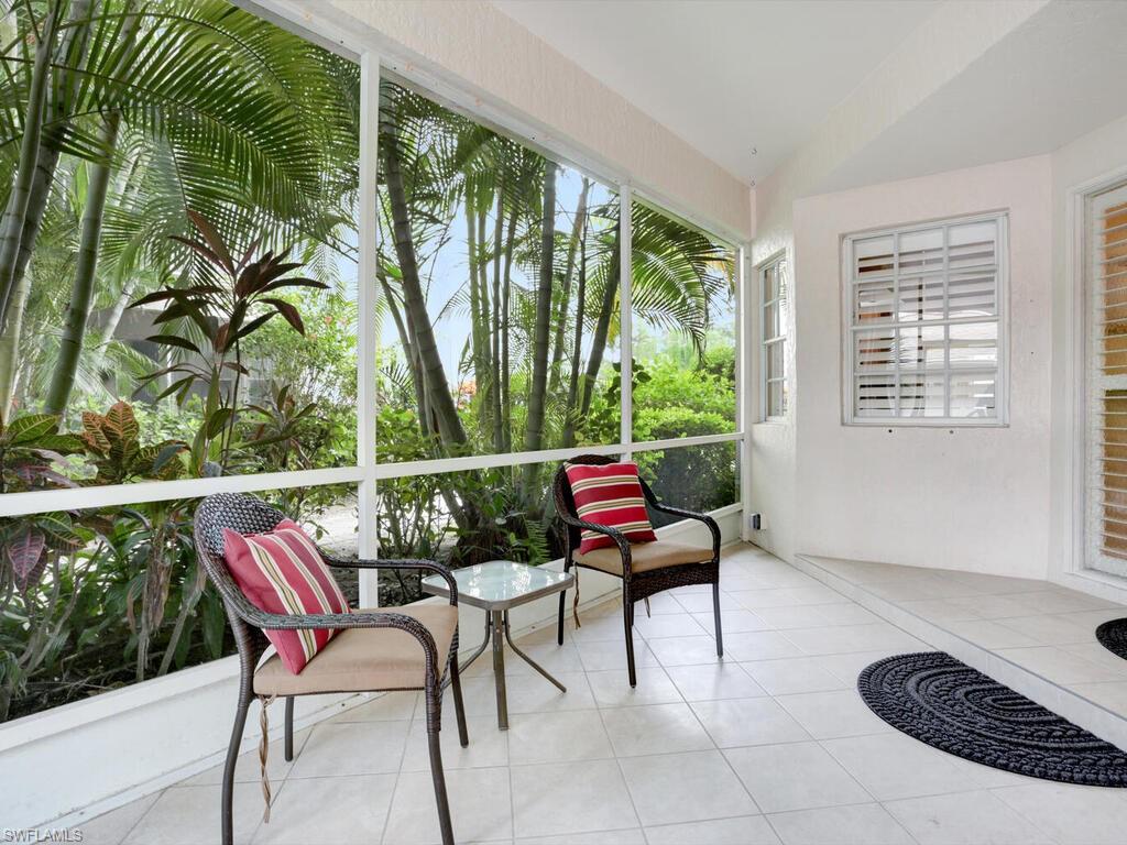 352 Bay Forest Drive, Unit 103 Naples, FL 34110 - Photo 26 of 30 a balcony with furniture and a potted plant