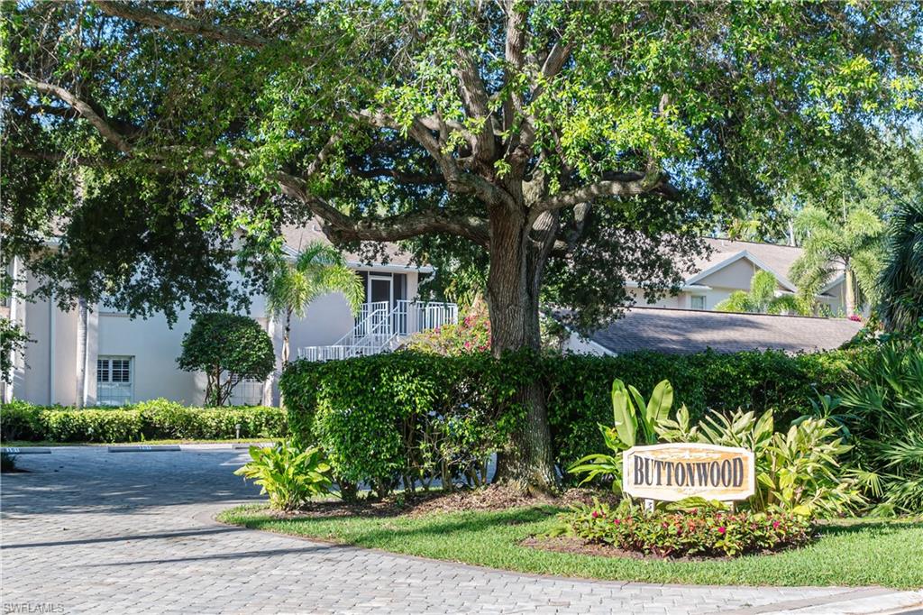 352 Bay Forest Drive, Unit 103 Naples, FL 34110 - Photo 27 of 30 a front view of a house with a yard and fountain