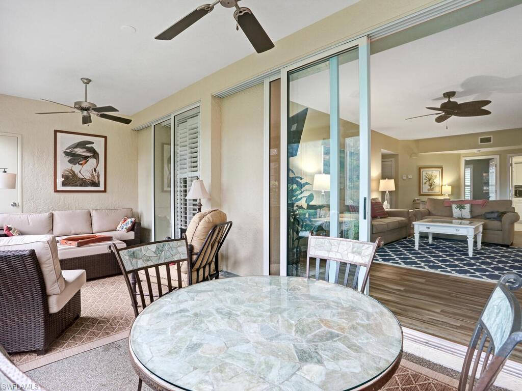 352 Bay Forest Drive, Unit 103 Naples, FL 34110 - Photo 3 of 30 a view of a livingroom with furniture window and wooden floor