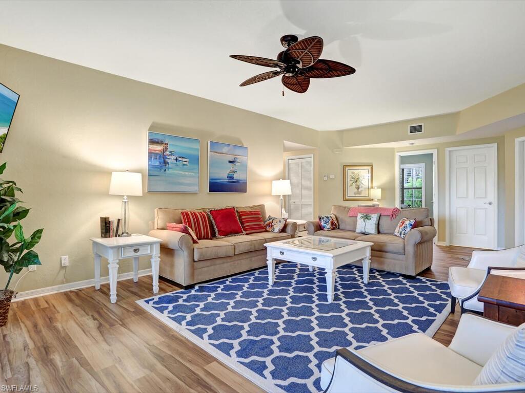352 Bay Forest Drive, Unit 103 Naples, FL 34110 - Photo 5 of 30 a living room with a couch and a window