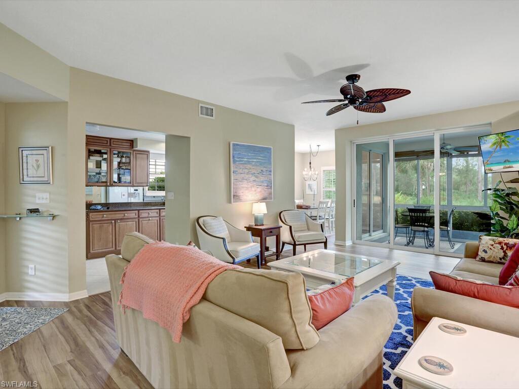 352 Bay Forest Drive, Unit 103 Naples, FL 34110 - Photo 7 of 30 a living room with furniture and a large window