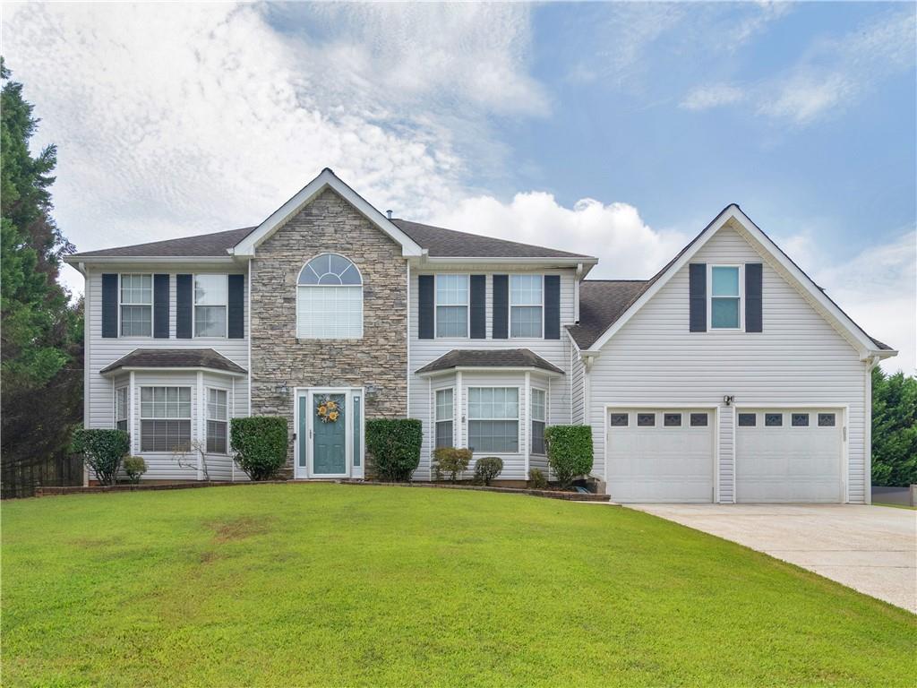 2141 Waters Run Decatur, GA 30035 - Photo 1 of 1 a front view of a house with a garden and yard