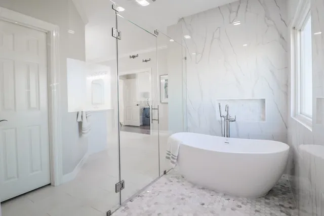 a bathroom with a bathtub and shower